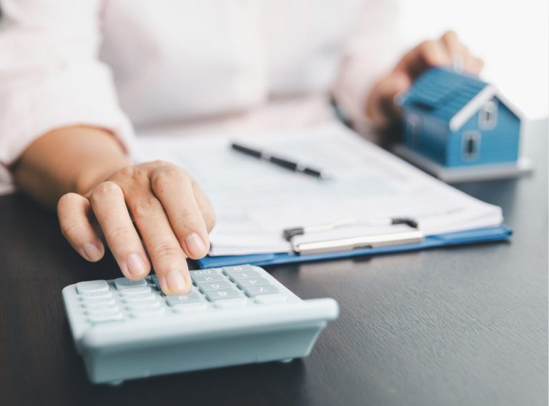 Homeowner calculating the average cost of homeowners insurance.
