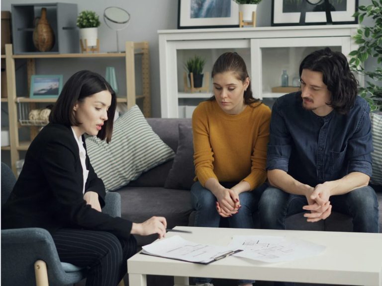 Insurance agent explaining policy options that impact the average cost of homeowners insurance.