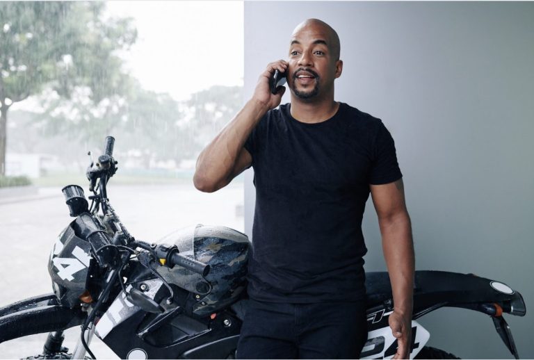 Motorcyclist on phone with Global Guard to get FREE motorcycle insurance quotes.